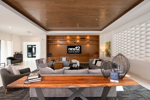 A modern living room with a wooden ceiling and a coffee table in the center.