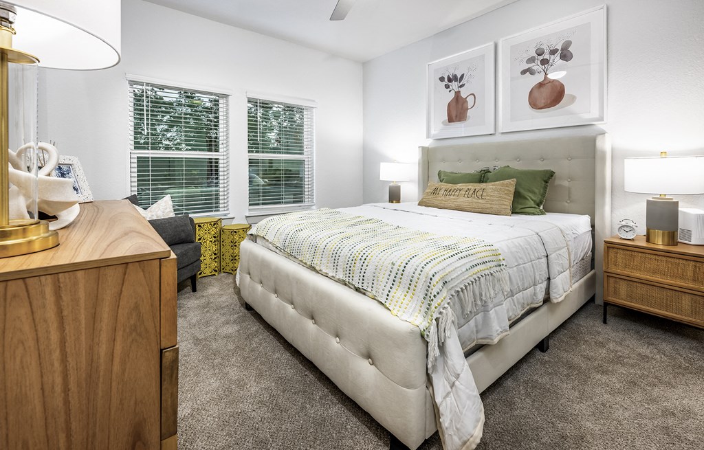 Luxury Apartments For Rent In Antioch, TN - Novo Hickory Highlands - Spacious Bedroom With Carpet Flooring, Ceiling Fan, And Windows For Natural Sunlight