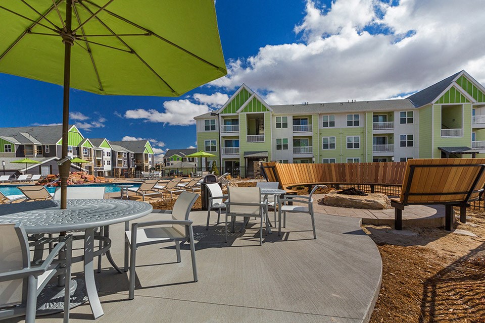 our apartments have a large patio with tables and chairs