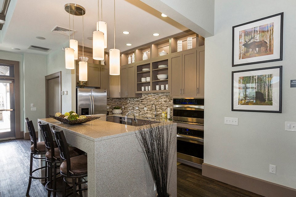 a kitchen with a large island with stools