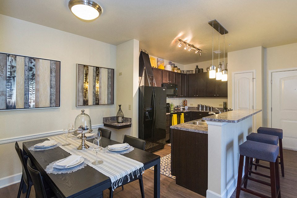 an open kitchen and dining room with a table and chairs