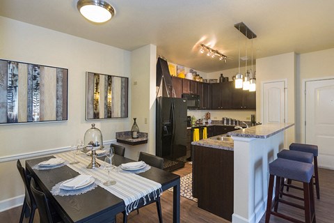 an open kitchen and dining room with a table and chairs