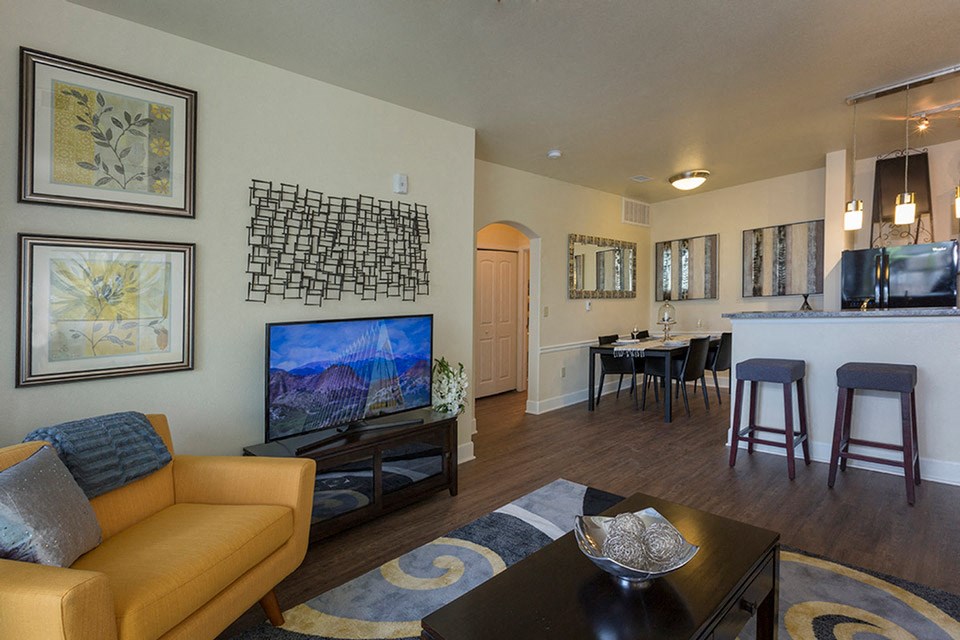 a living room and dining room with a couch and a tv