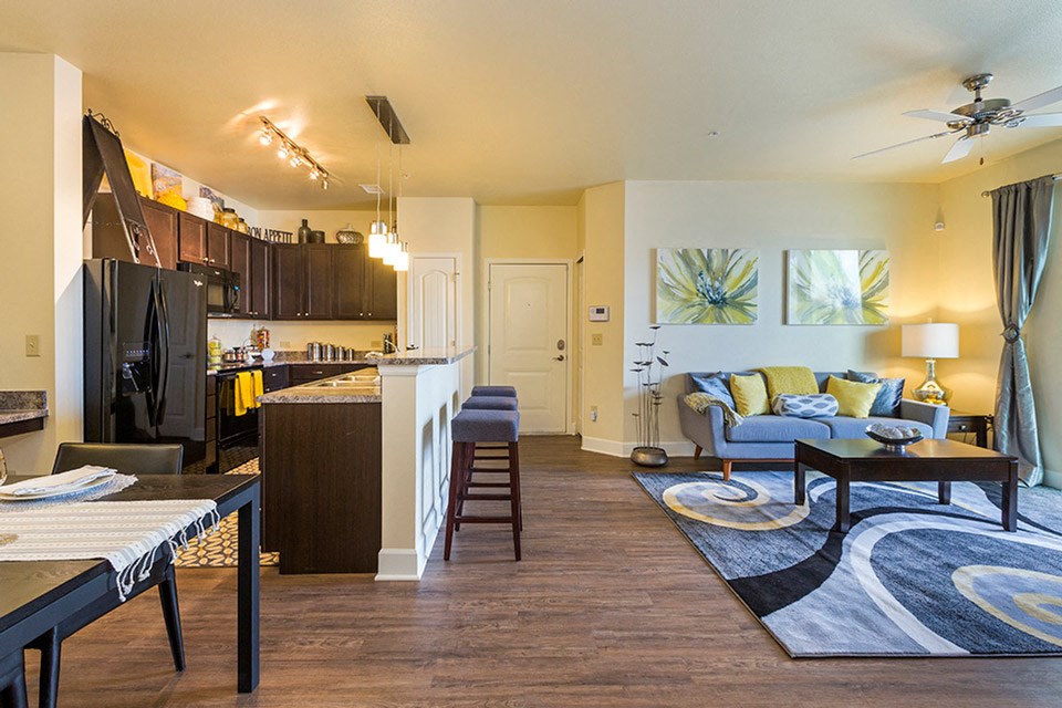 a living room and kitchen with a couch and a table