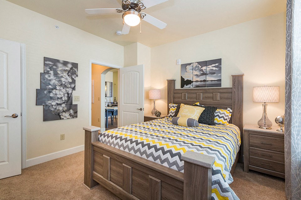 a bedroom with a bed and a ceiling fan