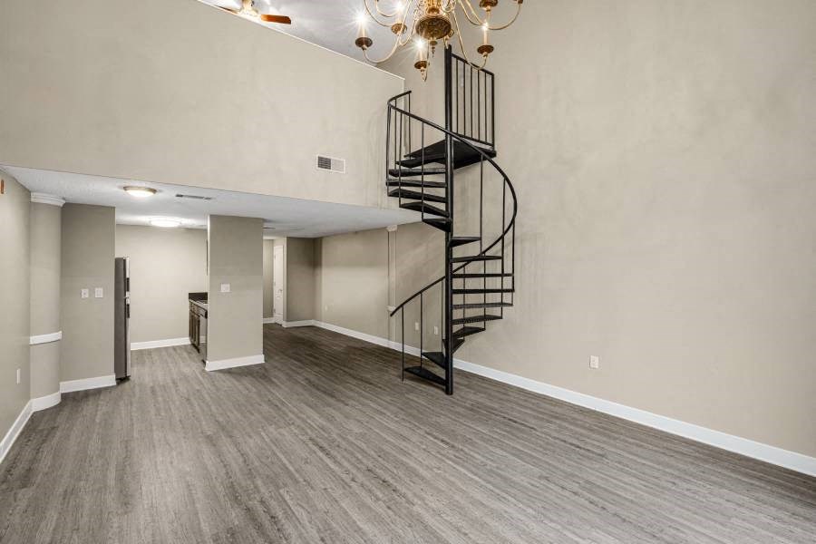 an empty living room with a spiral staircase