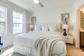 a bedroom with a large bed and two windows at Altis Grand Suncoast, Land O' Lakes, FL, 34638