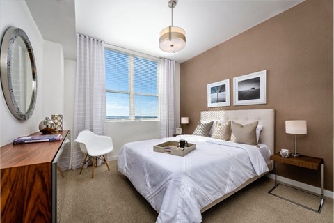 a bedroom with a bed and a desk with a chair