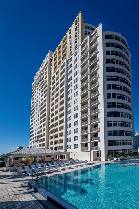 a large building with a pool in front of it