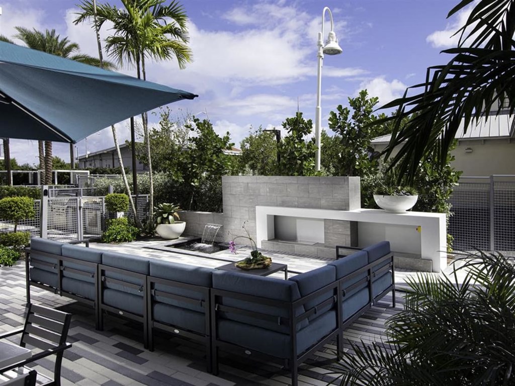 a patio with a fire pit and seating at Saba Pompano Beach, Pompano Beach, FL