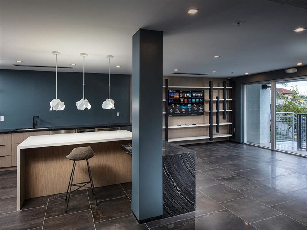a kitchen with a large island with a white countertop at Saba Pompano Beach, Pompano Beach, 33062