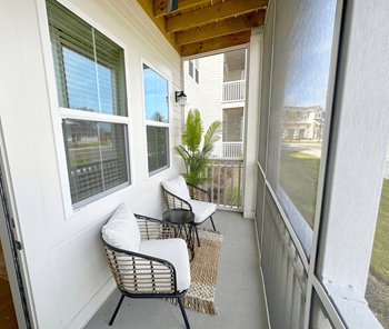 A balcony with a chair and table.