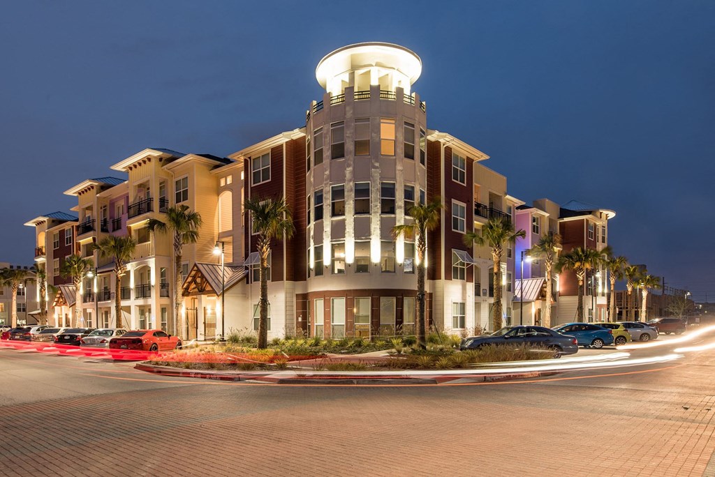 Lewisville, TX Apartments - Exterior View of Hebron 121 Station Apartments Building Surrounded By Lush Landscaping with Access to Parking