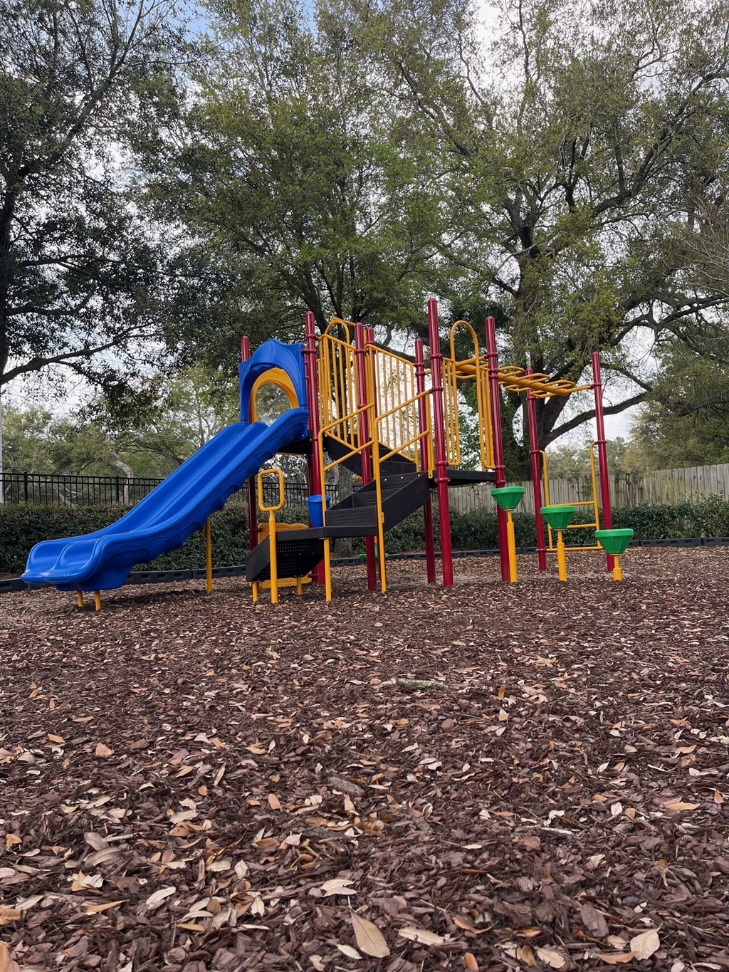 a playground with a blue slide and other toys