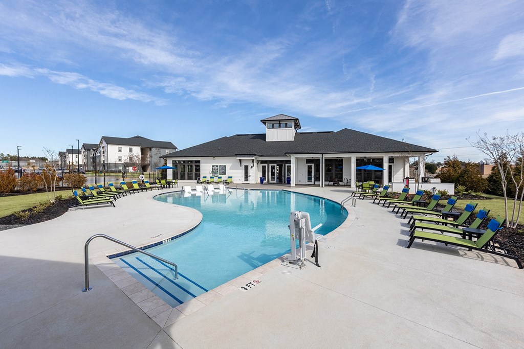 the preserve at ballantyne commons pool with lounge chairs and a building