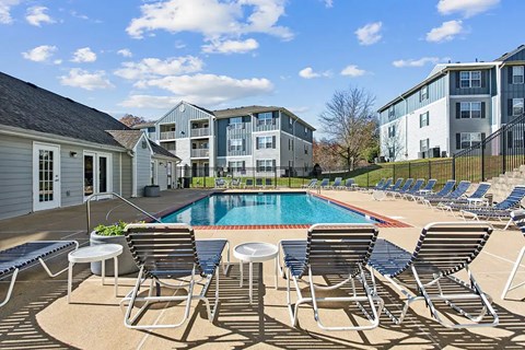 Apartments in Fredericksburg, VA, with In-Unit Washer and Dryer - England Run North Apartments - Resort-Style Swimming Pool With Lounge Chairs, Apartment Buildings, And Clubhouse.