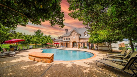 a swimming pool with a house in the background