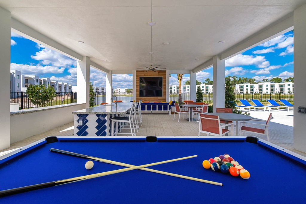 a games room with a pool table and chairs at Altis Blue Lake, Florida, 33467