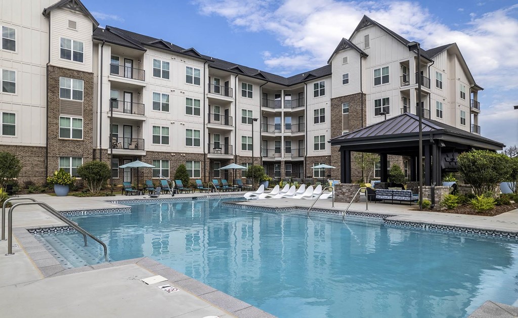 a swimming pool in front of an apartment building