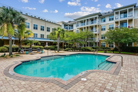 a swimming pool in front of an apartment building