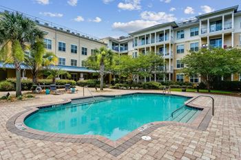 a swimming pool in front of an apartment building