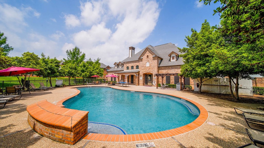 a swimming pool with a house in the background