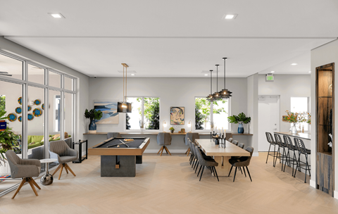 a living room with a table and chairs and a pool table