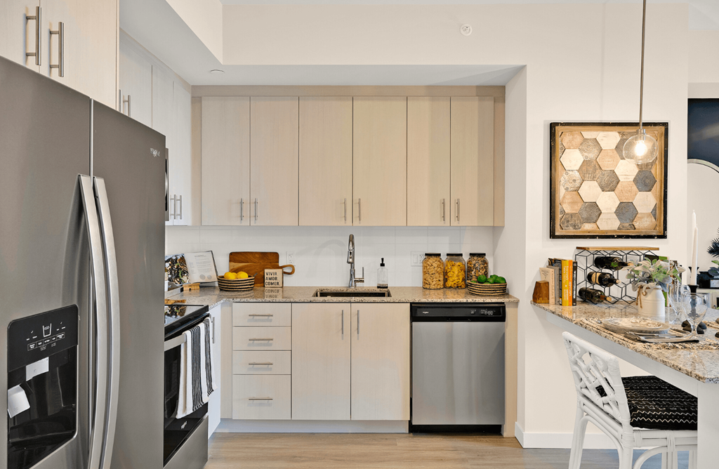 a kitchen with white cabinets and stainless steel appliances and a counter top