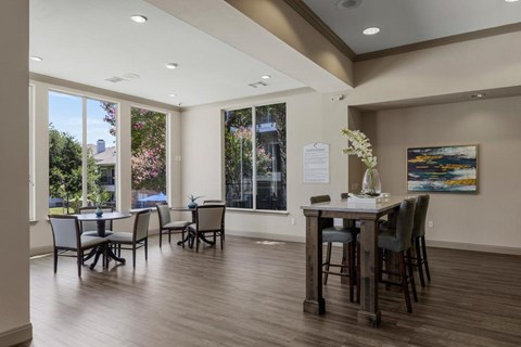 A dining room with a table set for six.