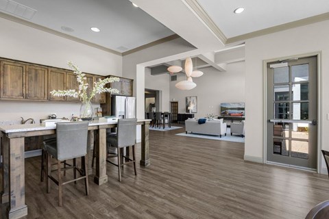 A kitchen with a dining table and chairs.