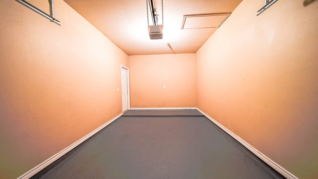 a empty room with orange walls and a gray floor
