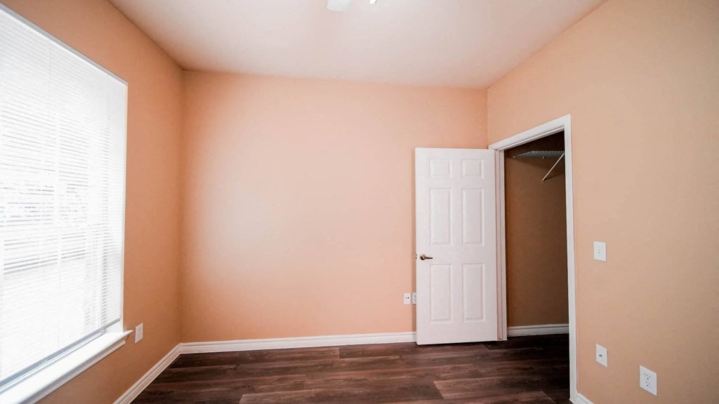 a room with a closet and a window and a door