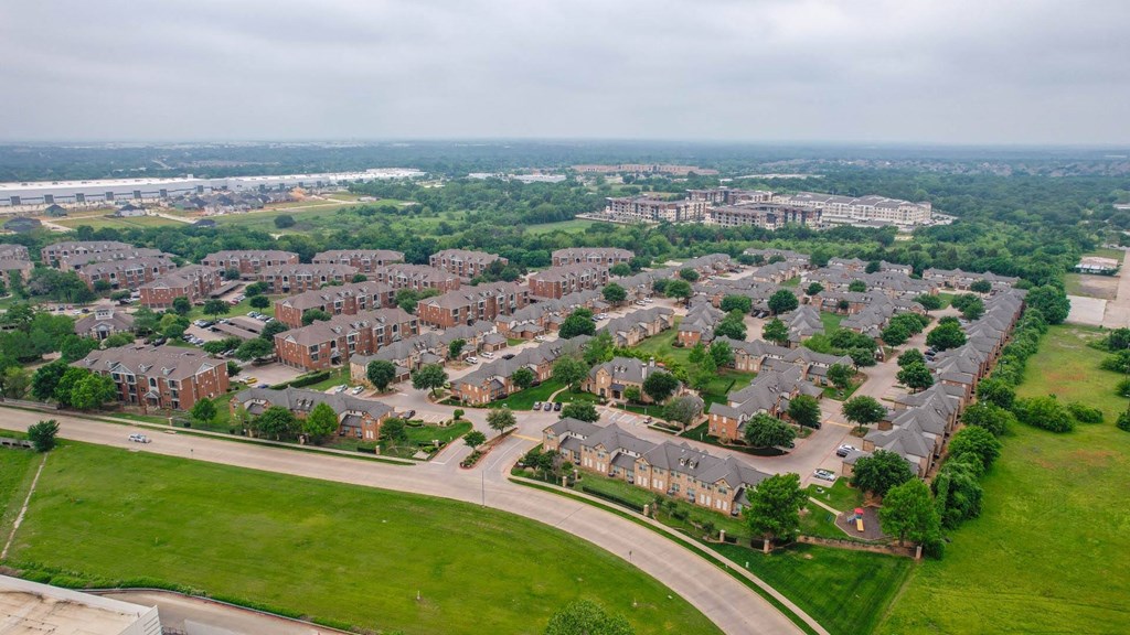 an aerial view of a neighborhood with houses and a road