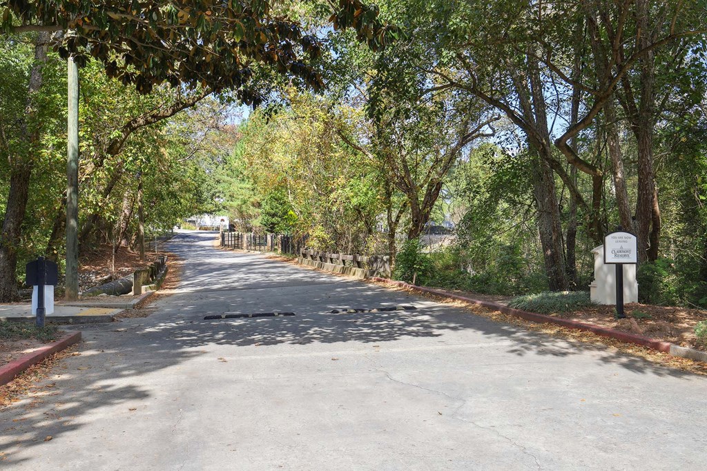 a wall with yellow and black stripes and a sidewalk