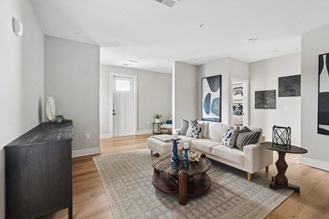 A living room with a white couch and a coffee table.