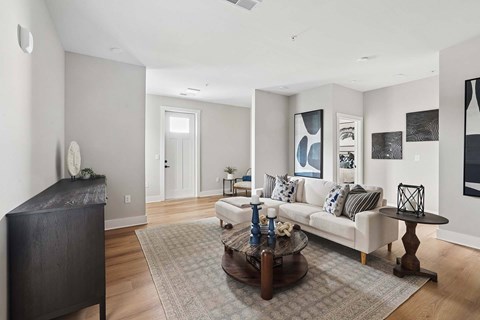 A living room with a white couch and a coffee table.