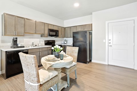 A kitchen with a table and chairs set for two.