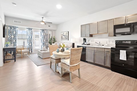 A kitchen with a dining table and chairs.