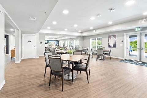 A dining room with a table and chairs.