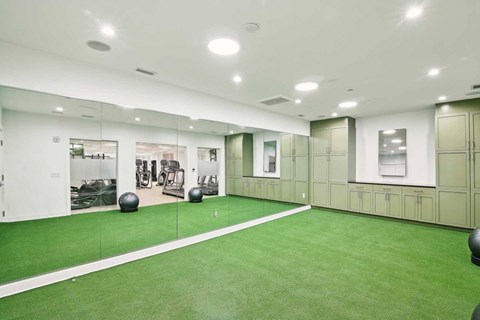 A gym with green flooring and white walls.