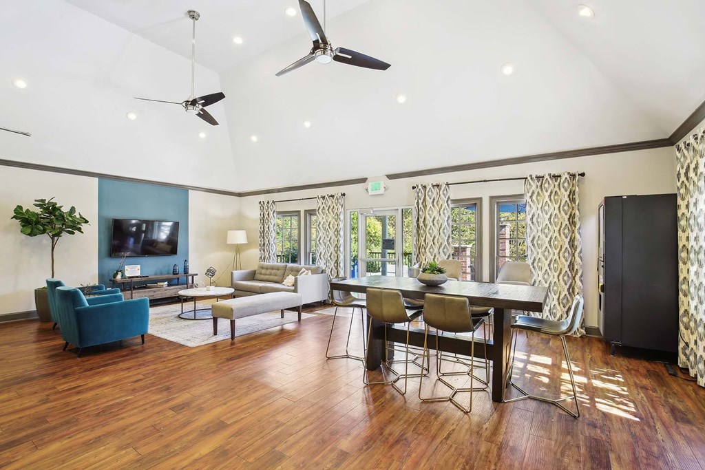 a living room and dining room with a table and chairs
