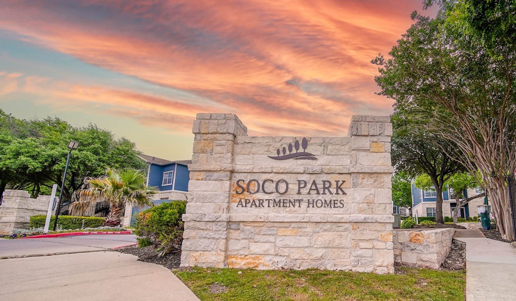 the entrance to scooby park apartment homes at sunset