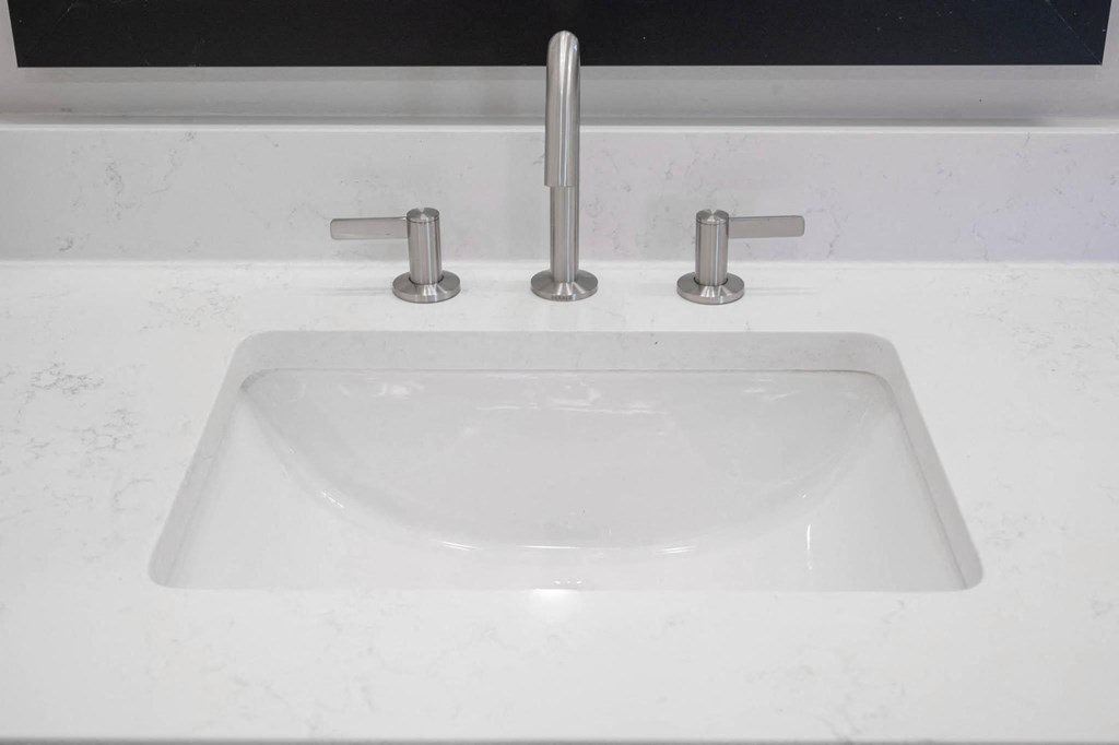 a white sink with a faucet on a counter top
