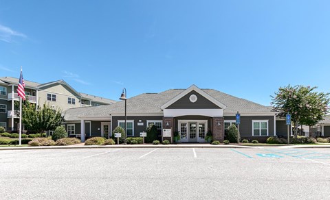 A building with a grey roof and a flag on the left side.
