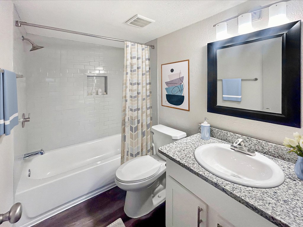 a bathroom with a sink toilet and bath tub
