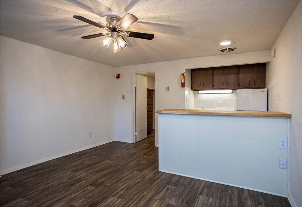 a kitchen and dining area in a bedroom plus den unit