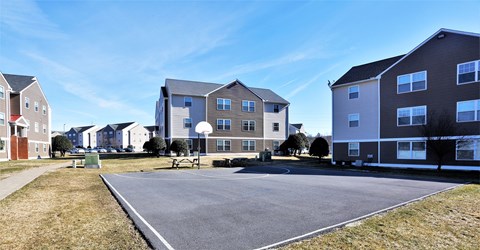 A parking lot in front of apartment buildings.