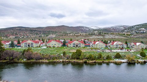 a group of houses sitting next to a body of water