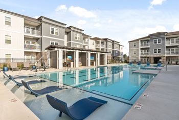 Sparkling saltwater swimming pool with in-pool tanning ledges, fountain sprays and three designated swimming lanes