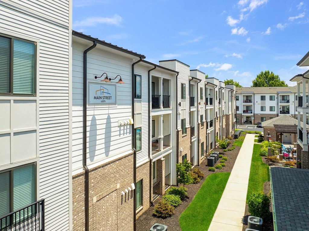 A row of townhouses with a sign that says Main Street.